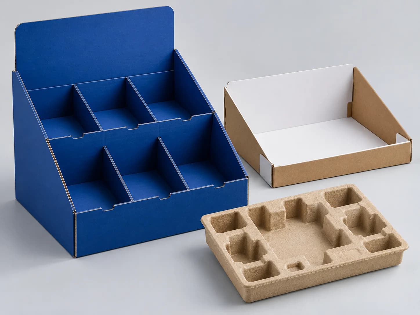 Cobalt modular display packaging beside a molded kraft paperboard insert