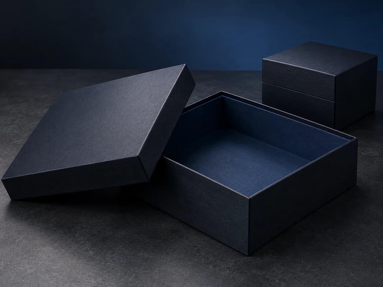 Matte navy rigid setup box with a separate lid and matching presentation boxes