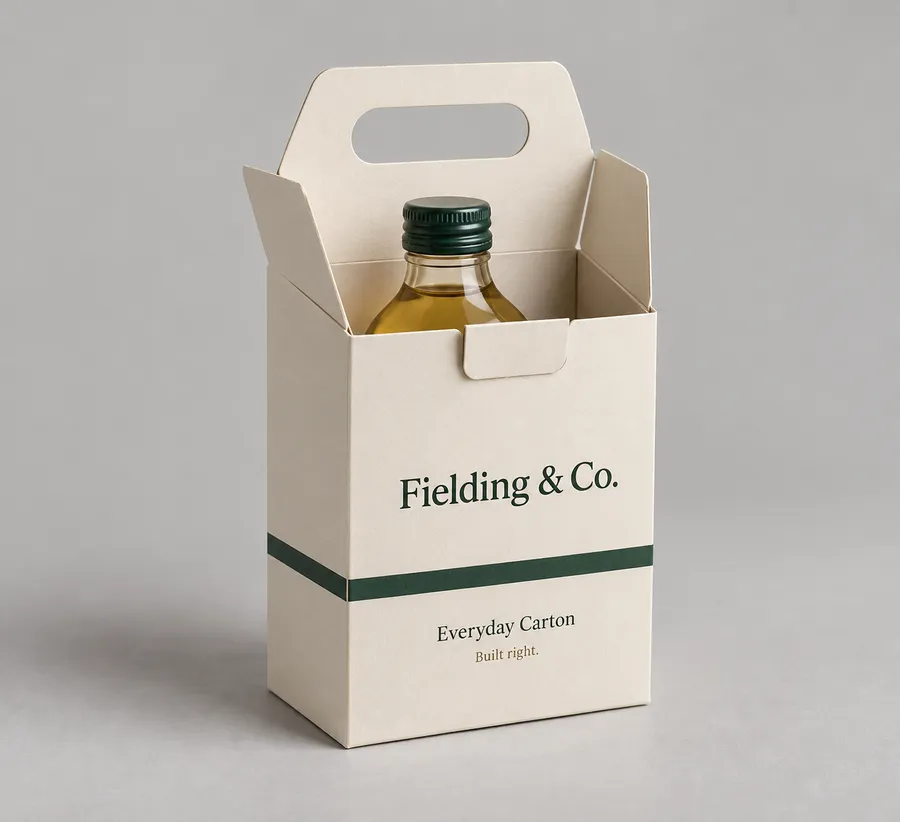 Open warm-ivory cardboard box with centered die-cut handle and amber bottle inside