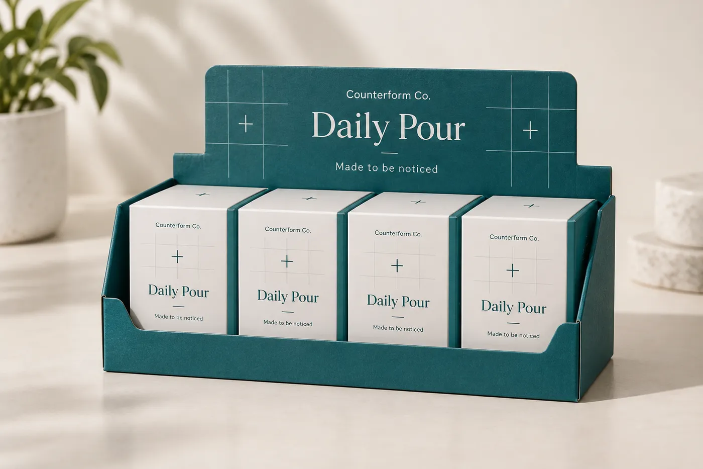 Deep-teal open-front pharmaceutical display box with four fictional medicine cartons and Counterform Co. header print.