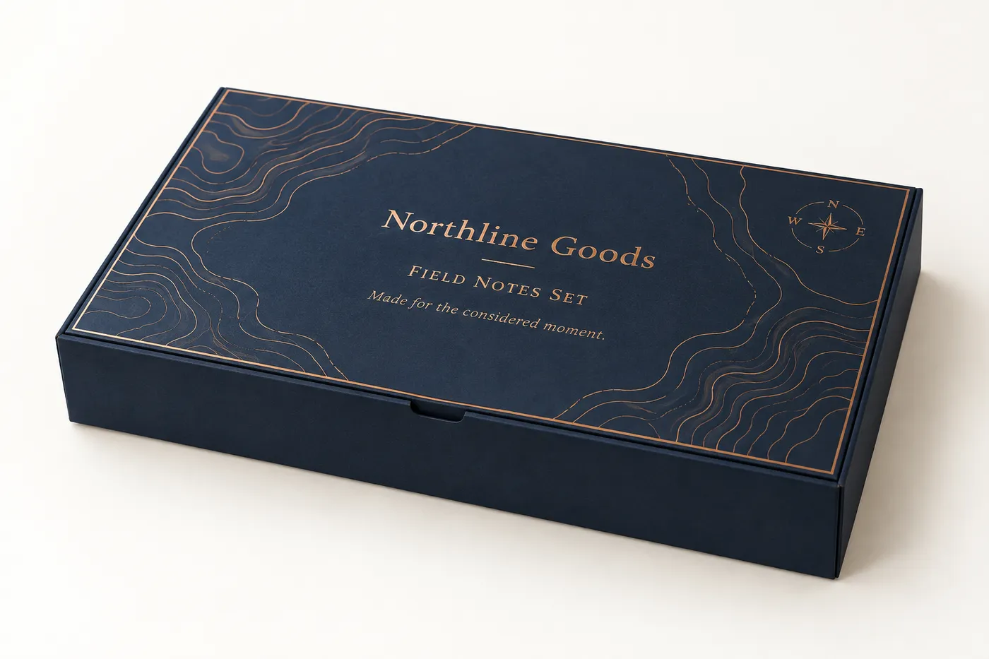 Closed ink-blue hinged lid rigid box with copper contour artwork and Northline Goods mockup