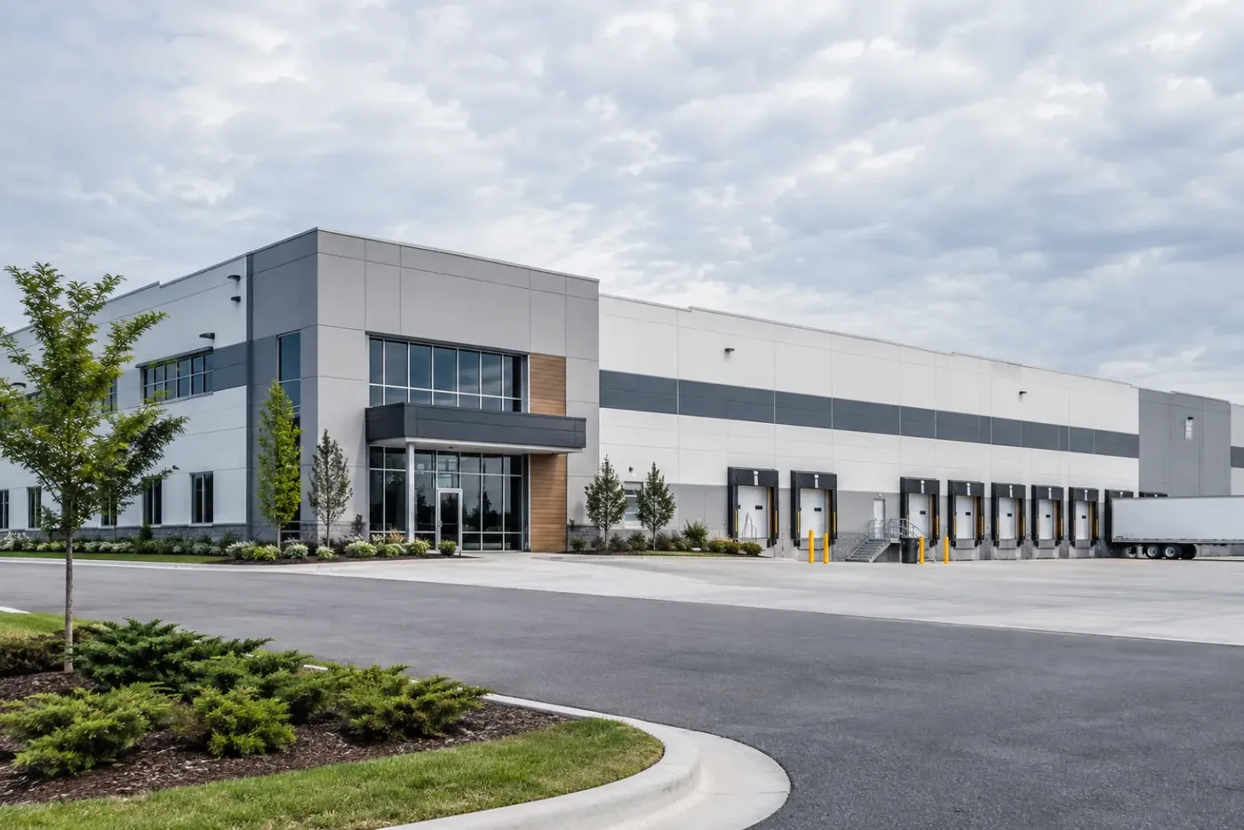 Modern commercial packaging manufacturing facility exterior with loading bays