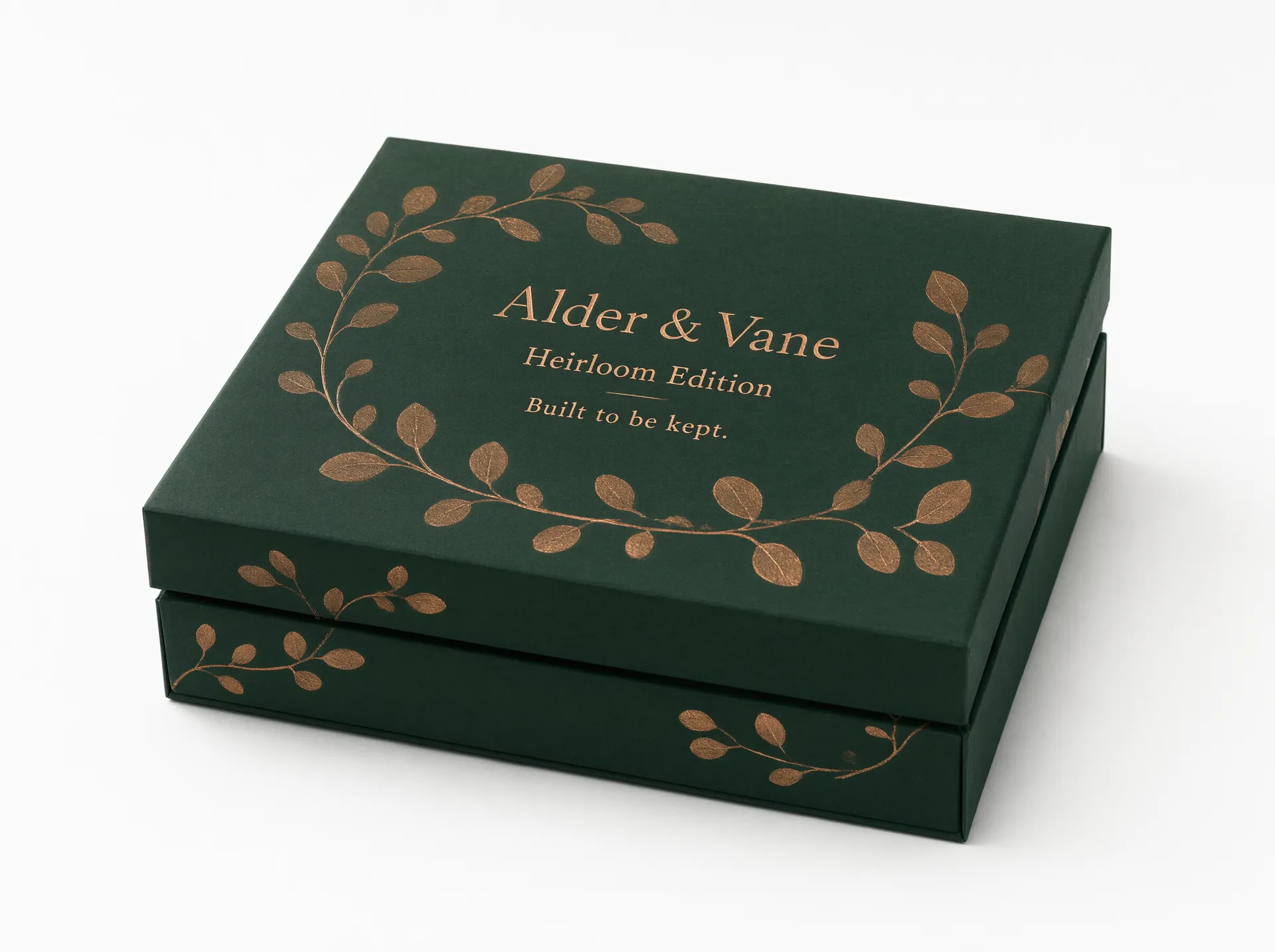 Closed forest green rigid gift box with a copper foil botanical motif and printed brand mockup