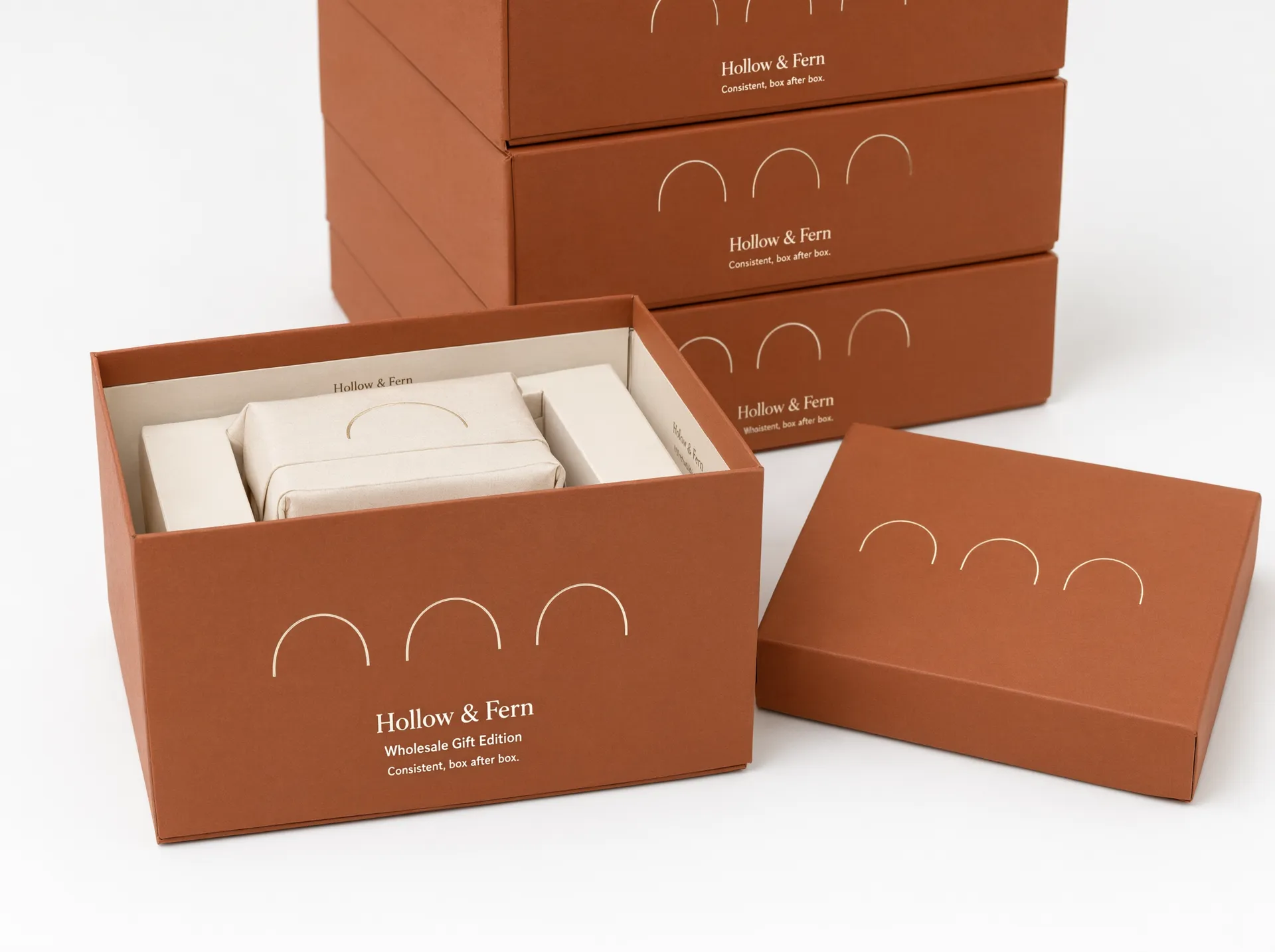 Terracotta gift box with lid removed, showing a wrapped item on a fitted paperboard riser