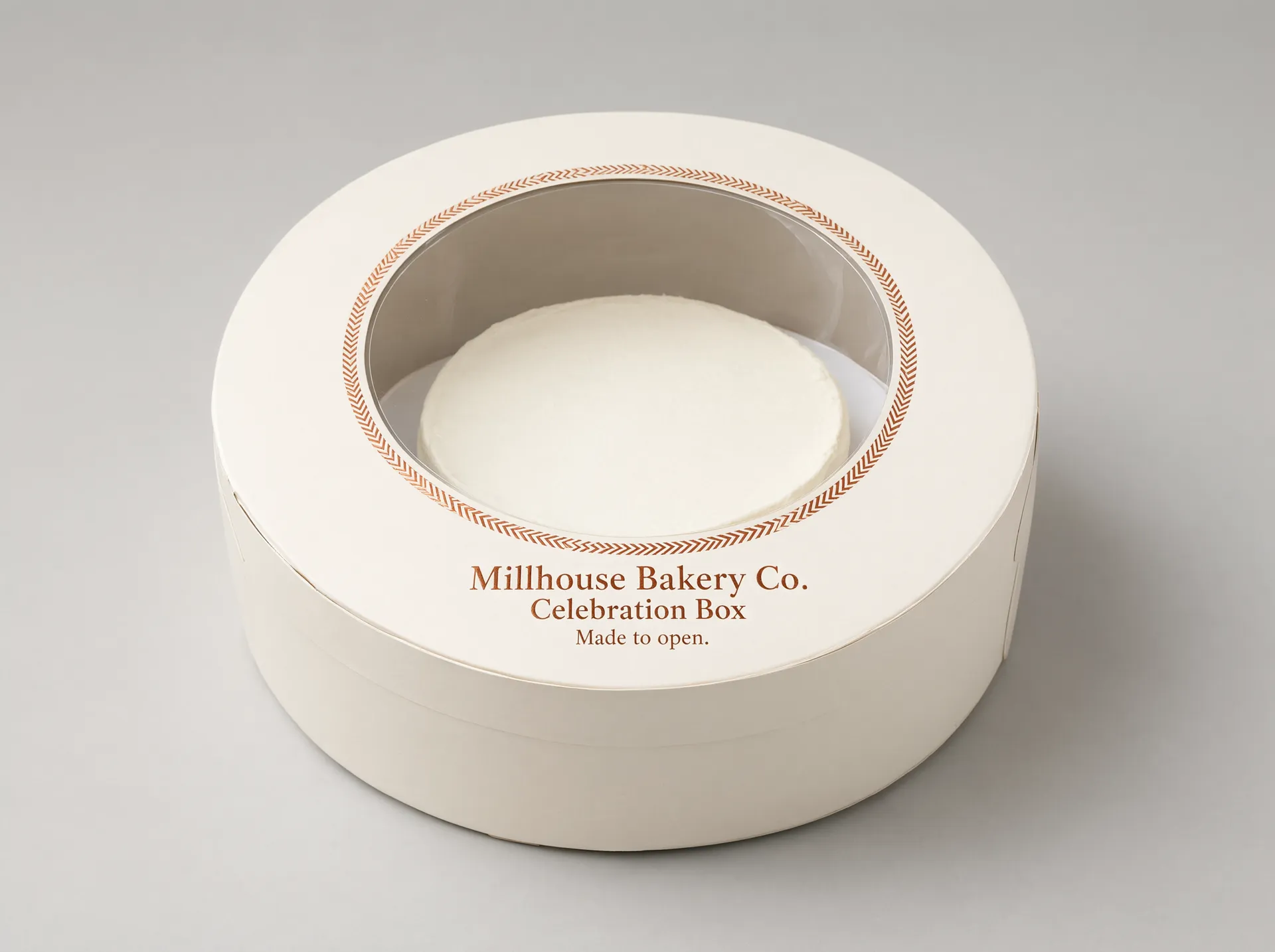 Window cake box showing a white-frosted cake through the die-cut window